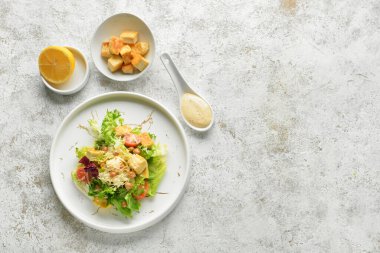 Hafif arka planda bir tabak lezzetli vegan Sezar salatası.