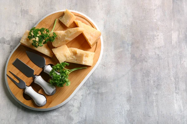 Wooden Board Pieces Tasty Parmesan Cheese Fork Knives Grey Background — Stock Photo, Image