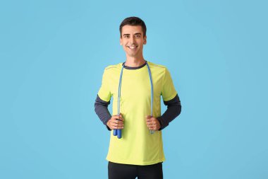 Renkli arka planda ip atlayan genç bir sporcu.