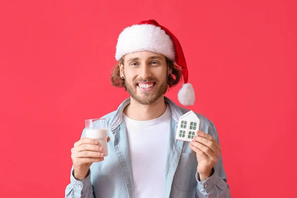 Young Man Santa Hat Christmas Cookie Glass Milk Red Background — Stock Photo, Image