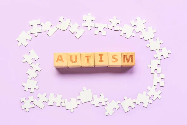 Cubes Word Autism Puzzle Pieces Lilac Background — Stock Photo, Image