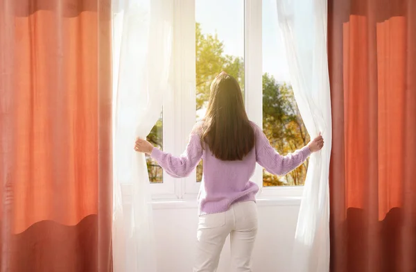 Pretty Young Woman Opening Curtains Room Sunny Day Back View — Stock Photo, Image
