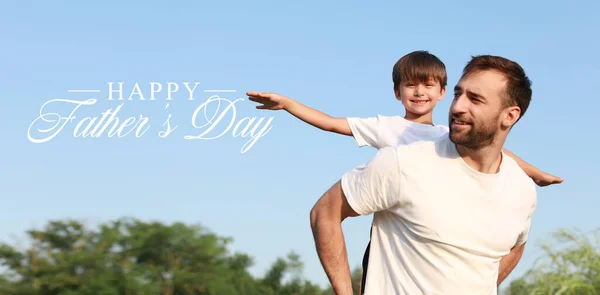 Greeting card for Happy International Father's Day with daddy and son outdoors