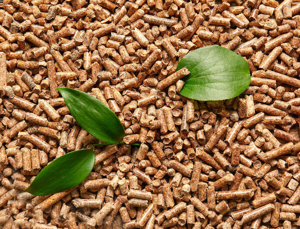 Wood pellets and leaves as background
