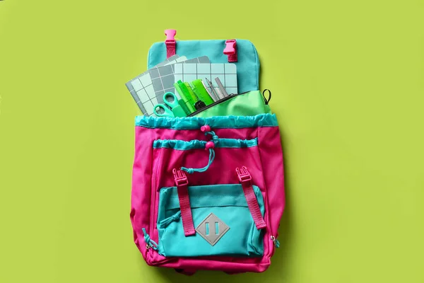 Lilac school backpack with stationery on blue background Stock Photo - Alamy