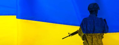 Erkek askerin silueti Ukrayna bayrağına karşı metin için alanı var.