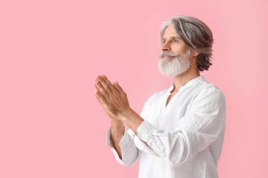Renkli arka planda olgun bir adam meditasyonu
