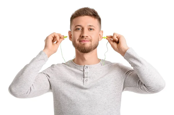 Young Man Putting Ear Plugs White Background — Stock Photo, Image
