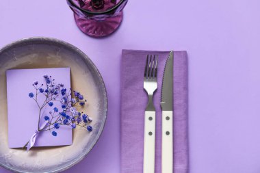 Mor arkaplandaki çiçekli basit masa ayarları
