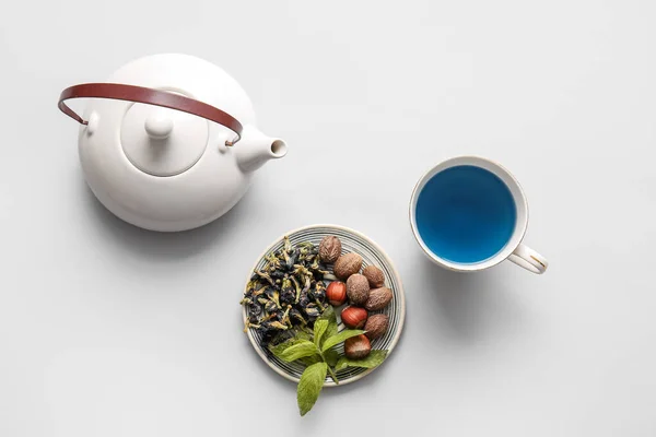 Tasse Blauer Tee Und Nüsse Auf Hellem Hintergrund — Stockfoto