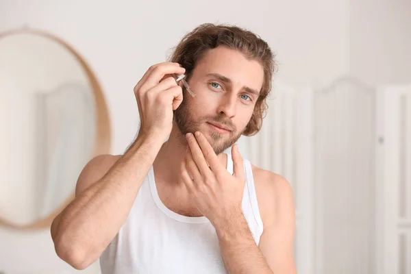 Young Man Using Serum Skin Care Bathroom — Stock Photo, Image