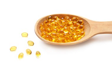 Beyaz arka planda jel haplı kaşık