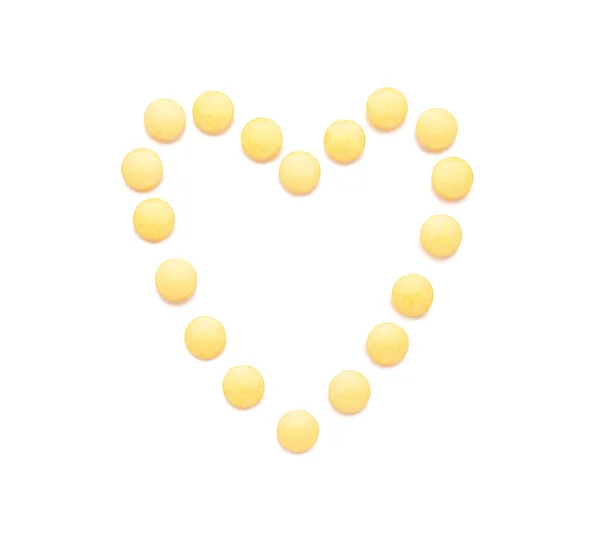 Hartvorm Gemaakt Van Gele Pillen Witte Achtergrond — Stockfoto