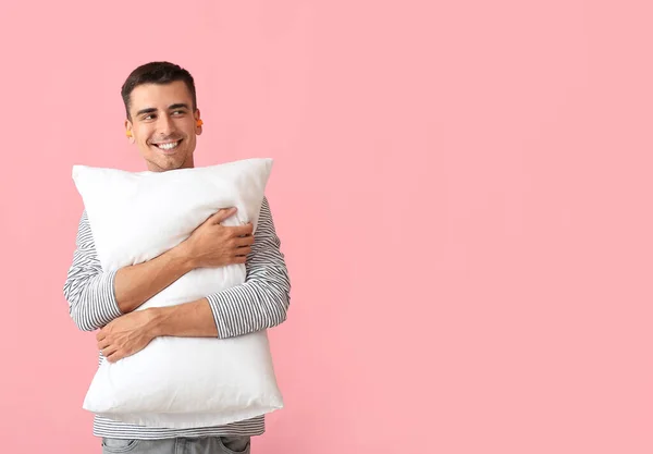 Young Man Ear Plugs Pillow Pink Background — Stockfoto