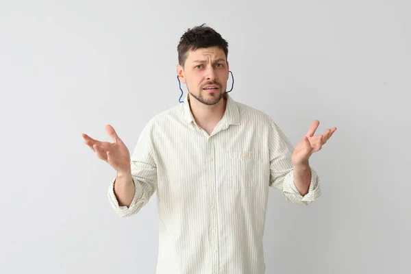 Confused Handsome Man Ear Plugs Light Background — Stock Photo, Image
