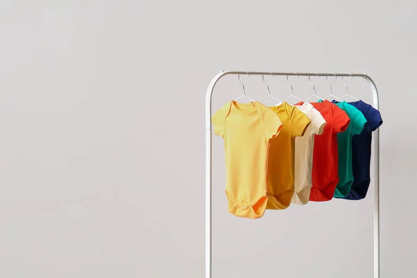 Rack Colorful Baby Bodysuits Light Wall — Stock Photo, Image