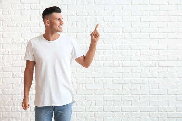 Handsome Young Man Stylish Shirt Pointing Something White Brick Background — Stock Photo, Image