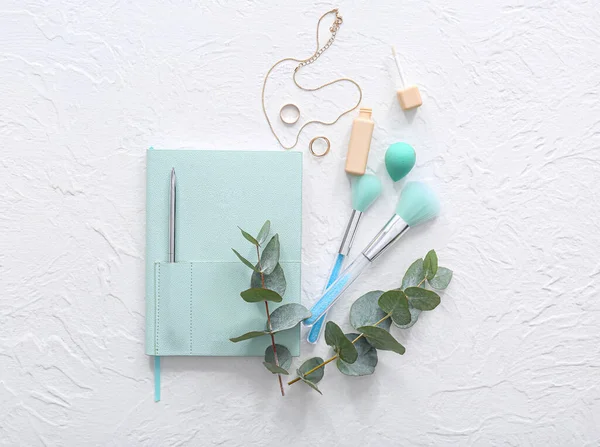 Stylish Notebook Eucalyptus Makeup Brushes Sponge Jewelry Lipgloss White Background — Stock Photo, Image
