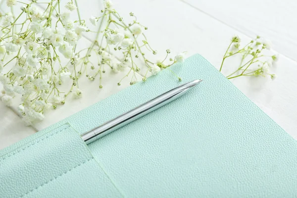 Stylish Notebook Pen Gypsophila Flowers White Wooden Background Closeup — Stock Photo, Image