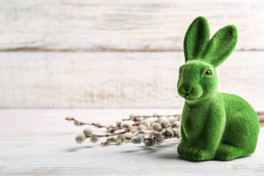 Cute Easter bunny and pussy willow branches on light background