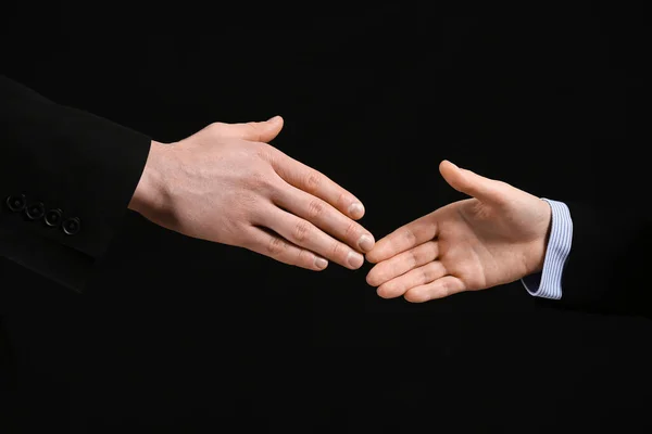 Business Workers Reaching Out Handshake Black Background Closeup — Stock Photo, Image