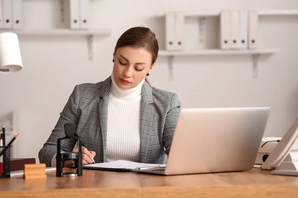 Female notary public working in office