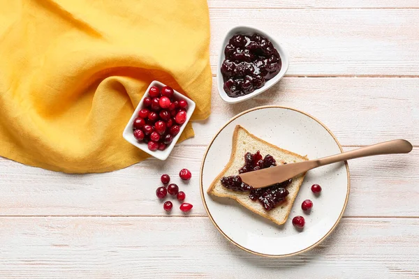 Spreading Tasty Lingonberry Jam Toast Knife Light Wooden Background — Stock Photo, Image