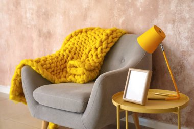 Lambalı, çerçeveli ve renkli duvarların yanındaki rahat koltuklu şık kahve masası.