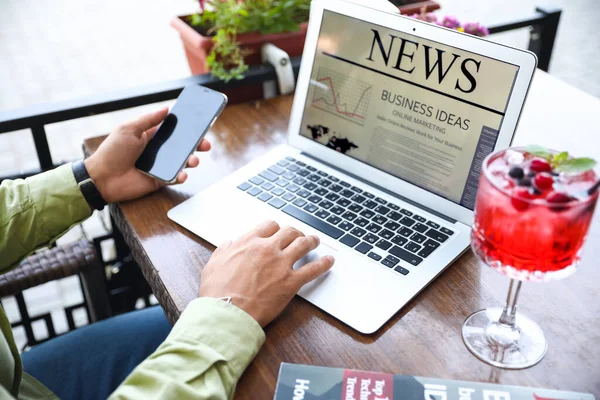 Young Man Mobile Phone Reading Newspaper Laptop Table Street Cafe — Stock Photo, Image