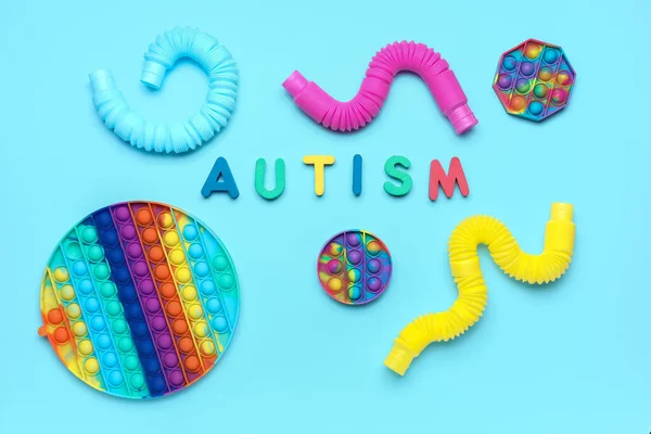 Word Autism Pop Fidget Zabawki Rurki Niebieskim Tle — Zdjęcie stockowe