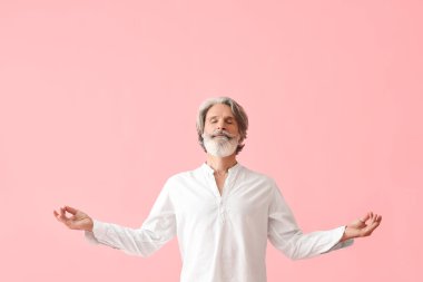 Renkli arka planda olgun bir adam meditasyonu
