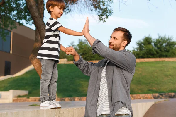 Ragazzino Che Cinque Suo Padre All Aperto — Foto Stock