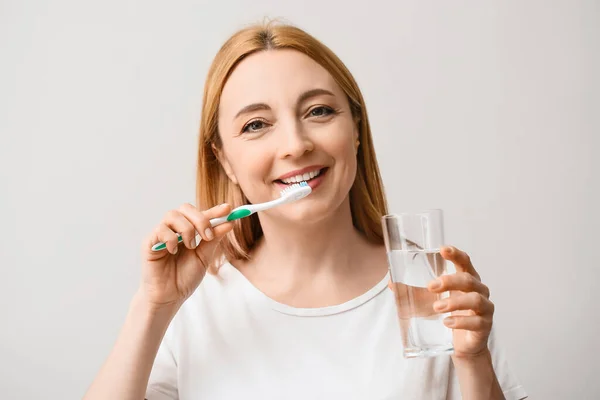 Beautiful Mature Woman Brushing Teeth Light Background — Stock Photo, Image