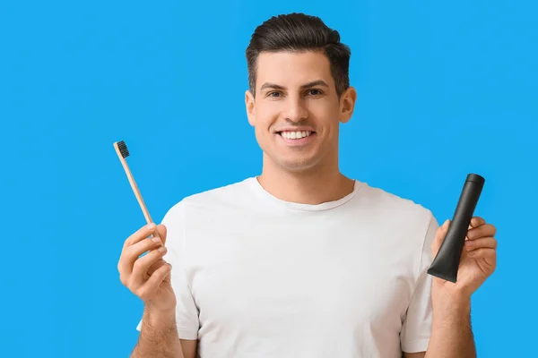 Handsome Young Man Activated Charcoal Tooth Paste Brush Blue Background — Stock Photo, Image