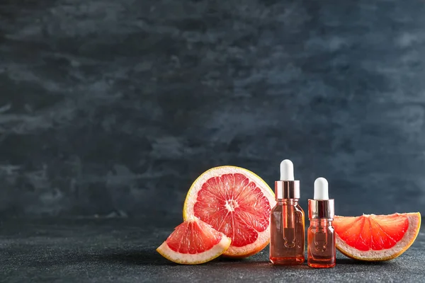 Bottles Essential Oil Ripe Grapefruit Dark Background — Stock Photo, Image