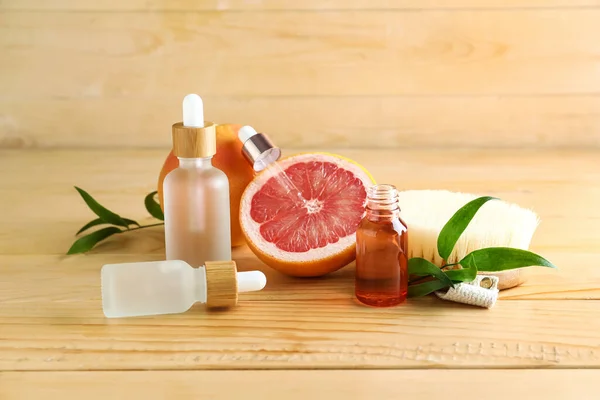 Bottles Essential Oil Grapefruit Massage Brush Wooden Background — Stock Photo, Image