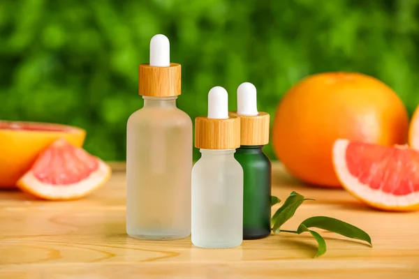 Bottles Grapefruit Essential Oil Wooden Table Outdoors — Stock Photo, Image