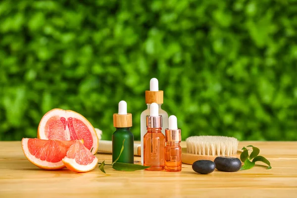 Composition Bottles Essential Oil Grapefruit Massage Brush Table Outdoors — Stock Photo, Image