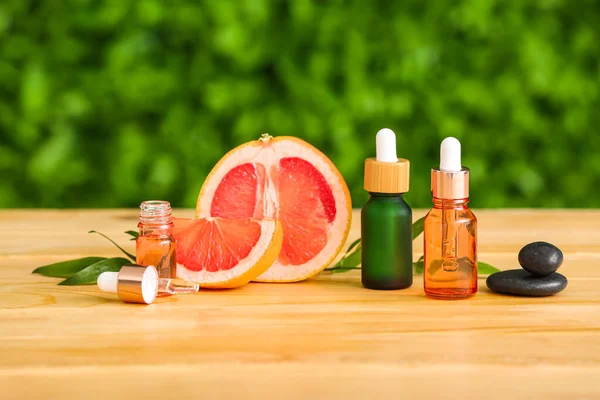 Bottles Essential Oil Grapefruit Wooden Table Outdoors — Stock Photo, Image