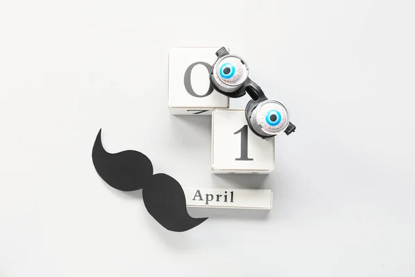 以浅色背景显示日期为4月1日的派对装饰和立方体日历 — 图库照片