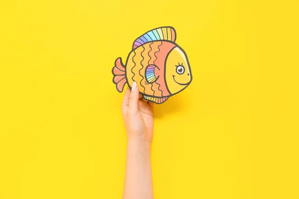 Female Hand Paper Fish Yellow Background April Fools Day Celebration — Stock Photo, Image