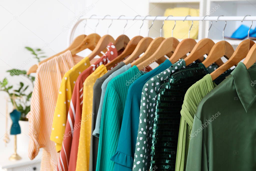 Rack with modern clothes in shop