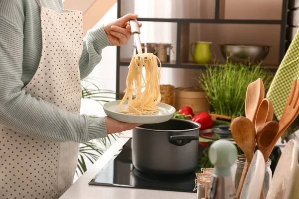 Woman Putting Delicious Pasta Plate Kitchen — Stock Photo, Image