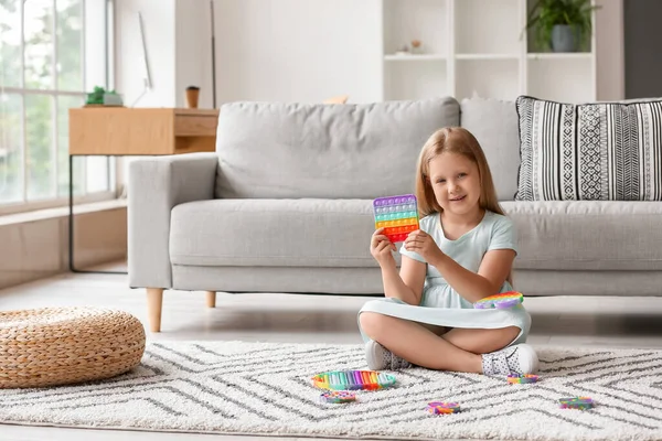 Little Girl Sitting Floor Holding Pop Fidget Toy Room — Stock Photo, Image