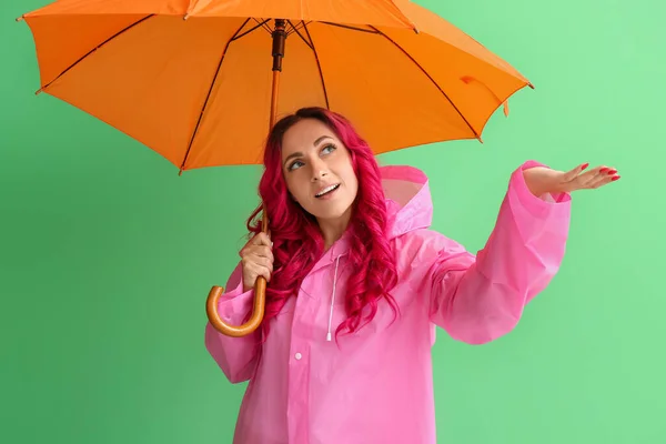 美しい女性でレインコートと傘の色の背景 — ストック写真