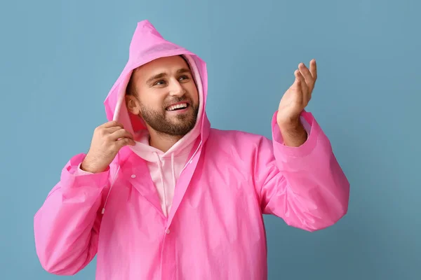 Young Man Stylish Raincoat Showing Something Color Background — Stockfoto