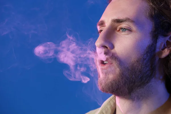 Rökning Ung Man Blå Bakgrund — Stockfoto