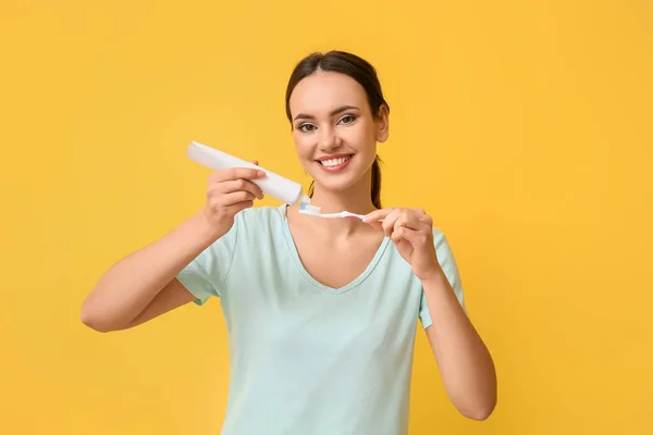 Pretty Young Woman Applying Tooth Paste Brush Yellow Background — Stock Photo, Image