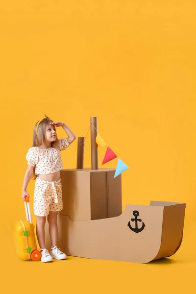 Cute Little Girl Playing Cardboard Ship Yellow Background — Stock Photo, Image