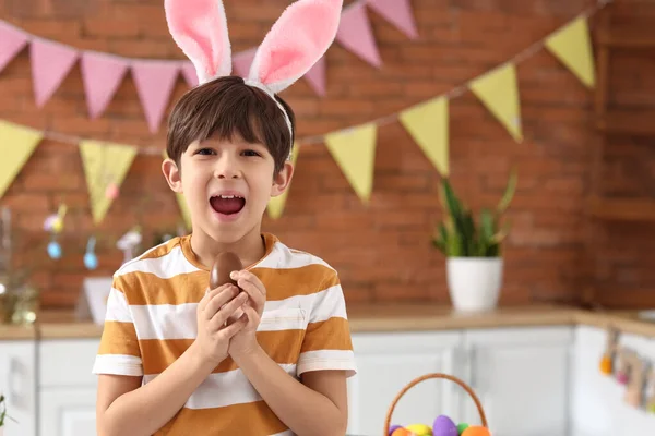 Cute Little Boy Bunny Ears Eating Tasty Chocolate Easter Egg — Stock Photo, Image